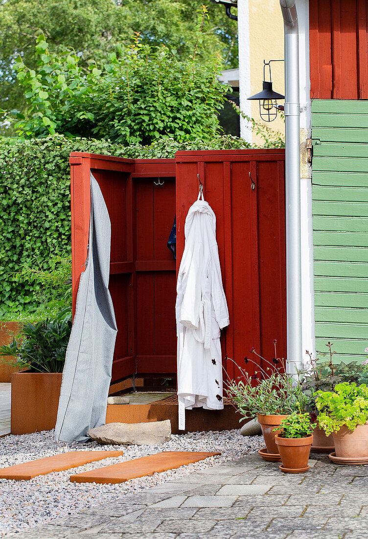 Changing room with red wooden walls in the outdoor area