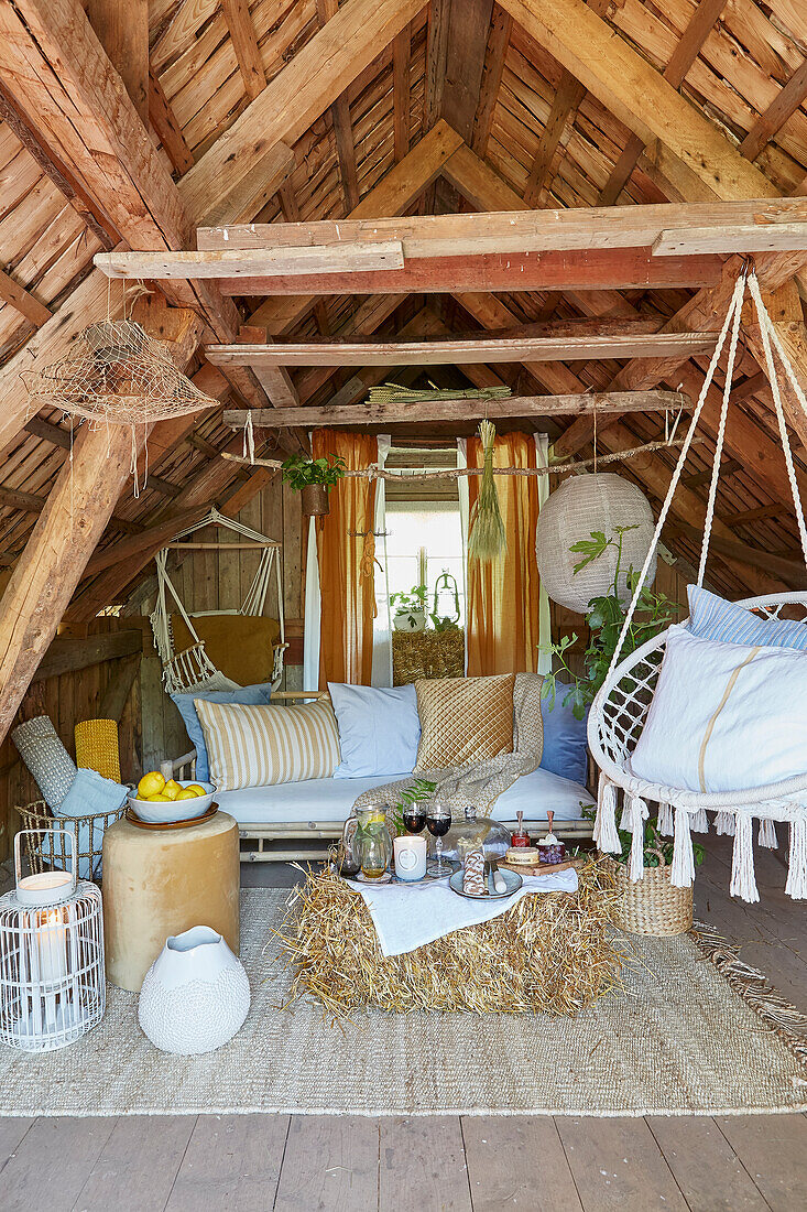 Rustic attic lounge with hanging chair and natural materials