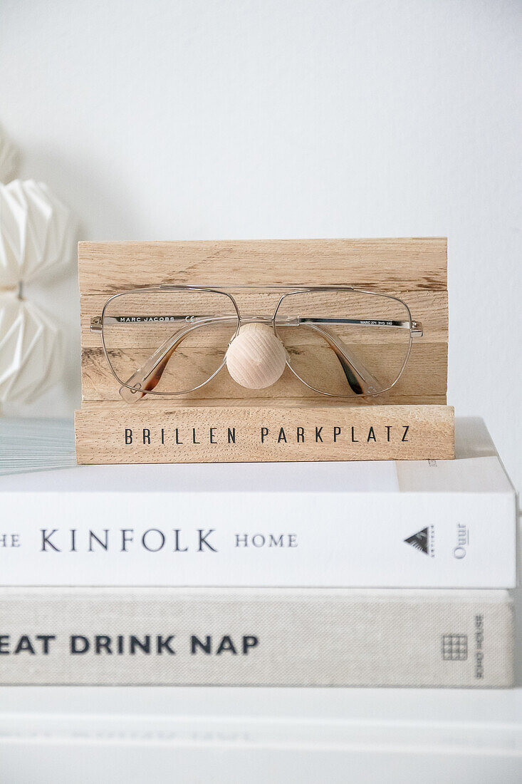 Wooden glasses holder on a decorative stack of books