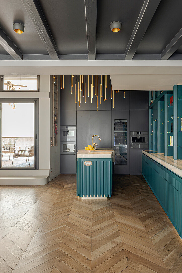 Open-plan kitchen with golden pendant lights in a modern design, herringbone parquet flooring