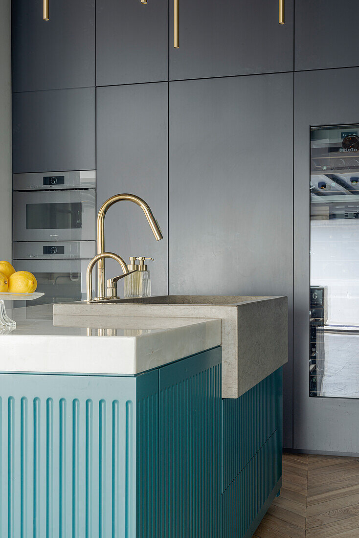 Modern kitchen with golden fittings