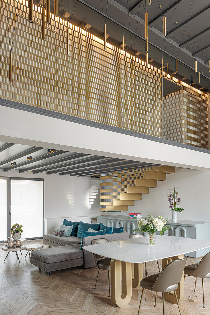 Open-plan living room with herringbone parquet flooring and gallery