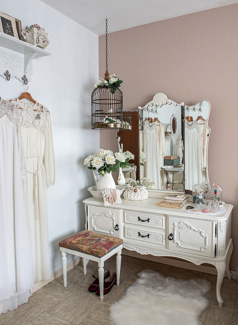 Vintage dressing table with white roses and antique mirror