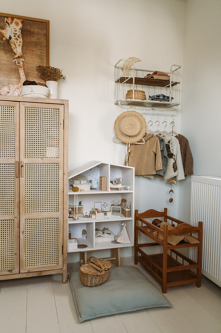 Children's room with rattan cupboard, doll's house and wardrobe