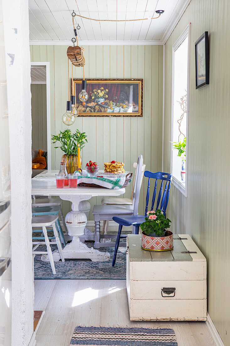 Dining room with wooden furniture and flowers, country house style