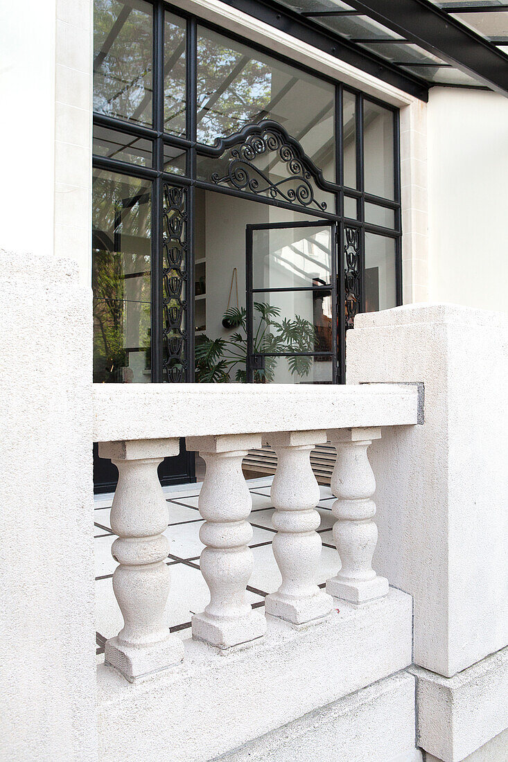 Elegant veranda with steel and glass doors and balustrade