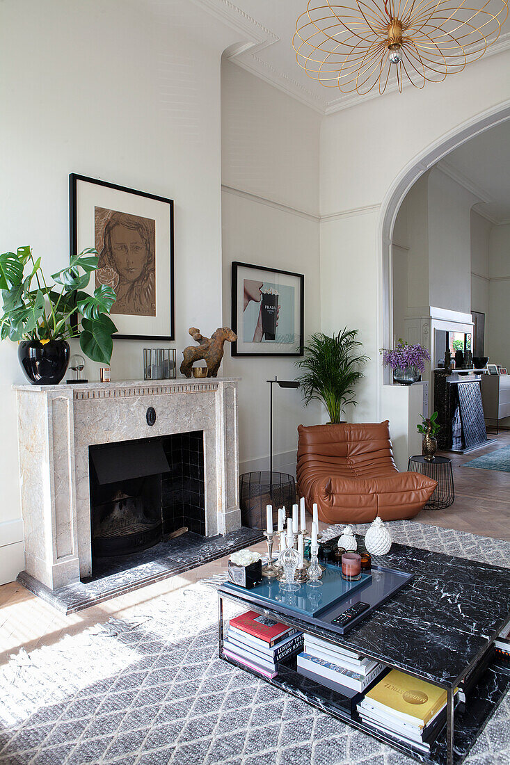 Living room with fireplace, leather armchair and marble coffee table