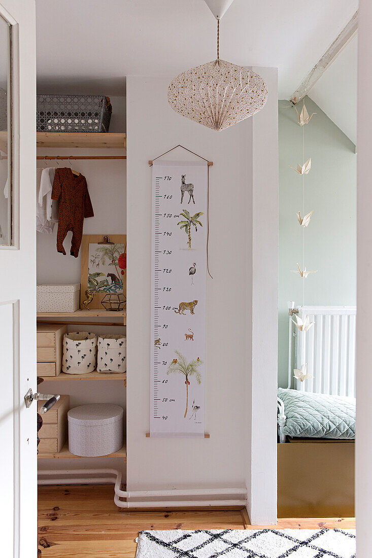 Children's room with measuring stick, shelves and bed