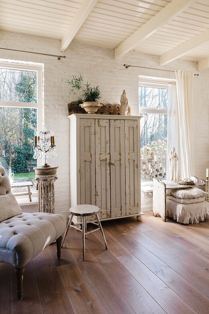 Bright living room with shabby chic cabinet and wooden floor