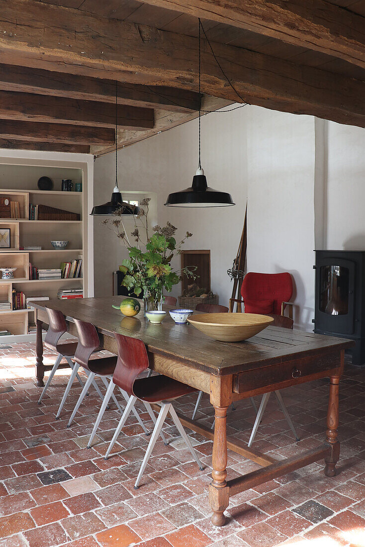 Rustic dining room with rustic wooden table and brick floor