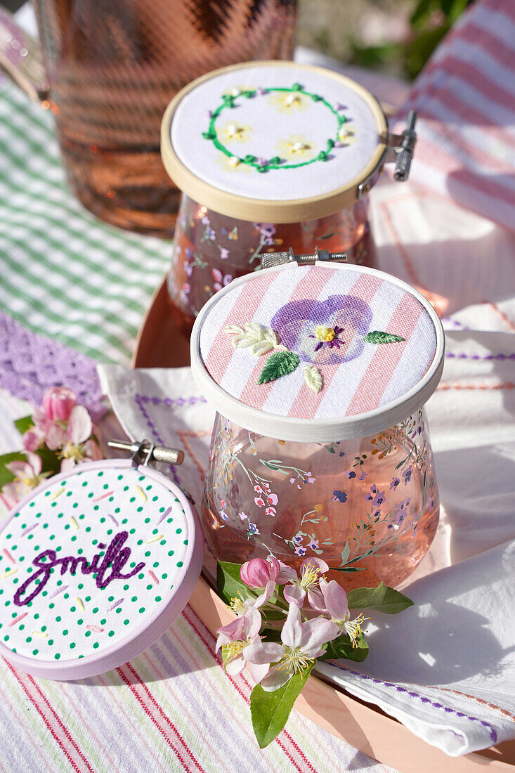 Embroidered glass covers with floral pattern and ""smile"" lettering