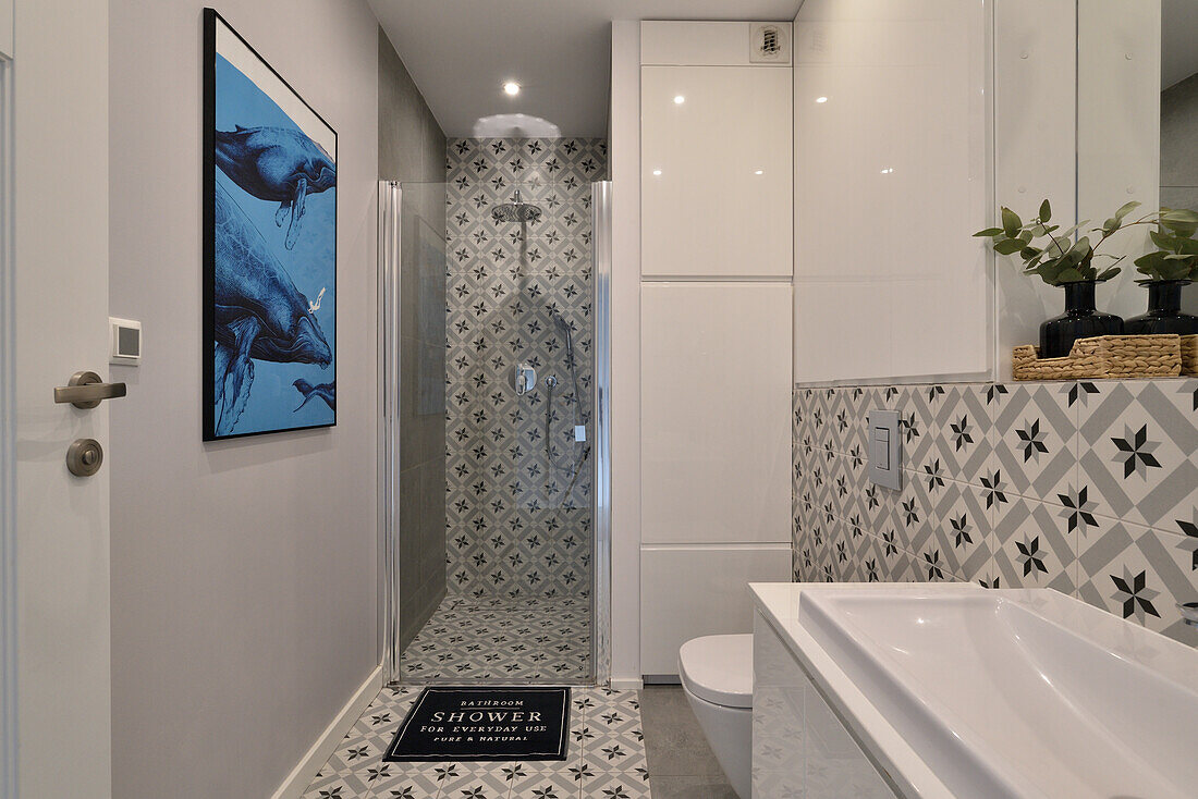 Modern bathroom with patterned tiles and wall art