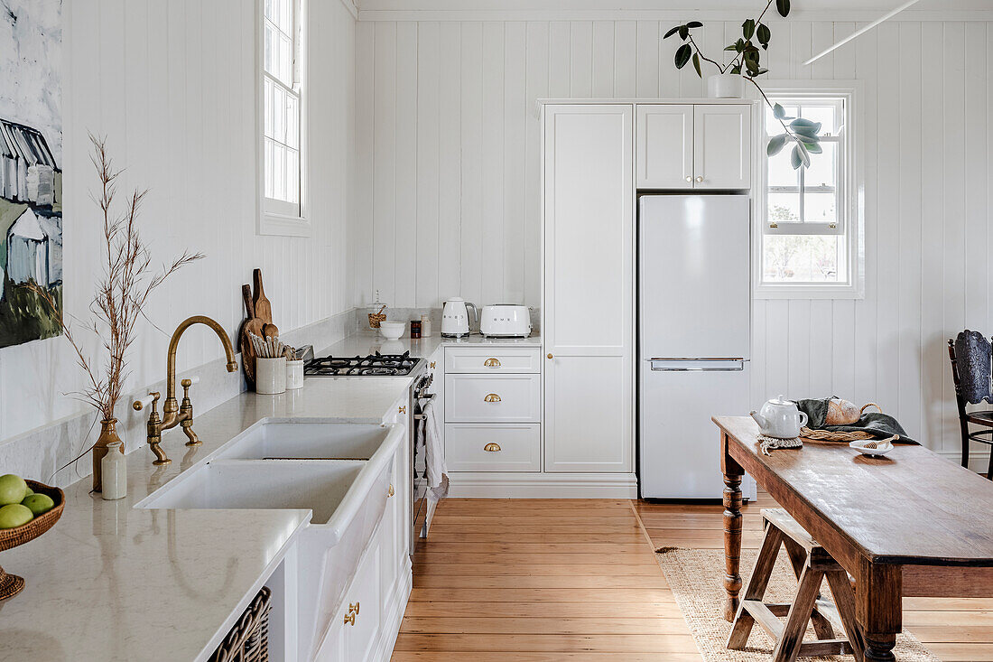 Rural kitchen in white with wooden table