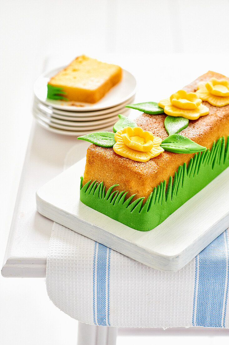 Loaf tin cake with yellow flowers and green leaves made from fondant