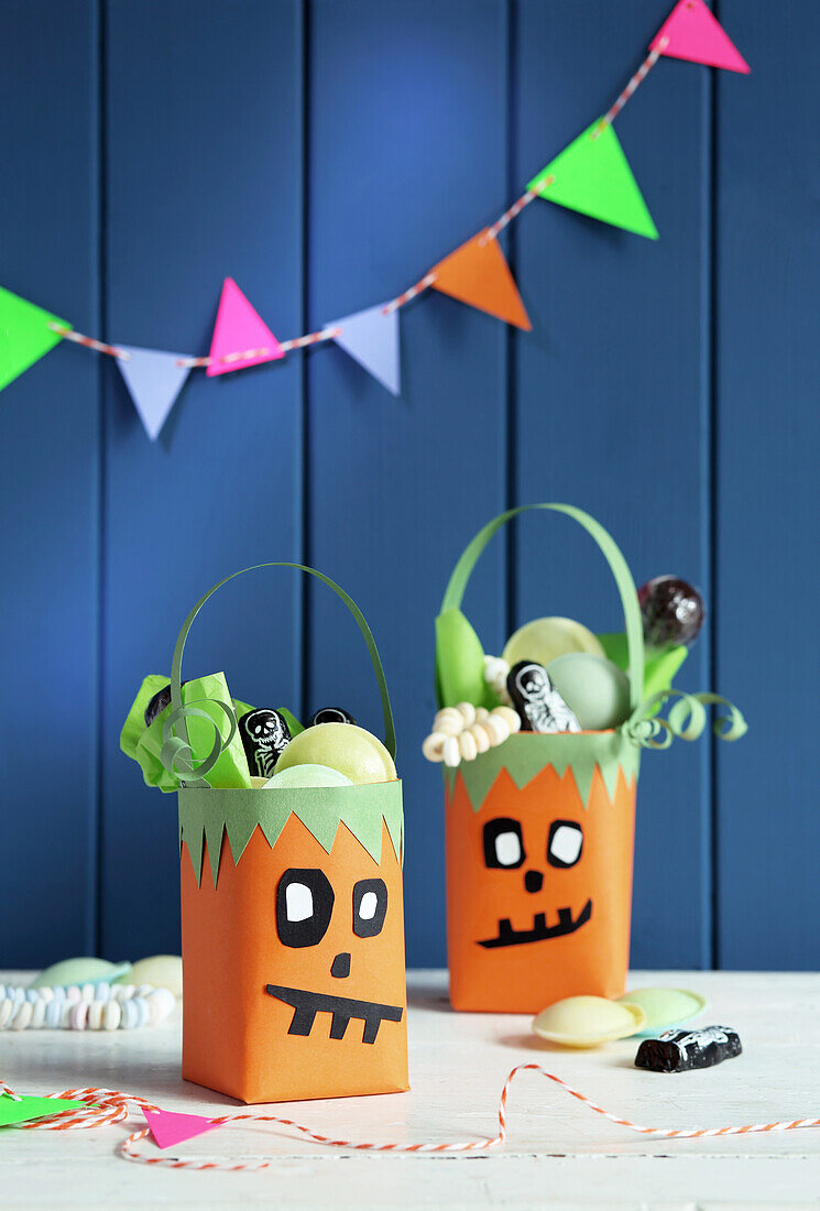 Homemade Halloween gift bags made from Tetrapaks with funny pumpkin faces