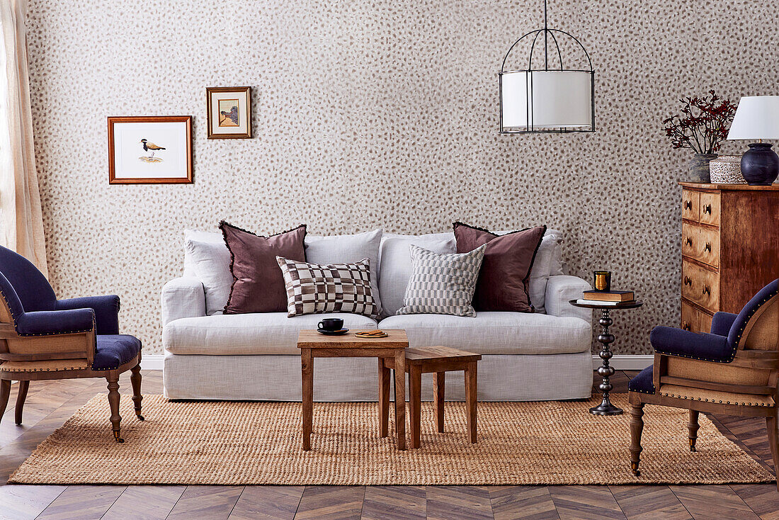 Rustic living room with patterned wallpaper, sisal rug and wooden furniture