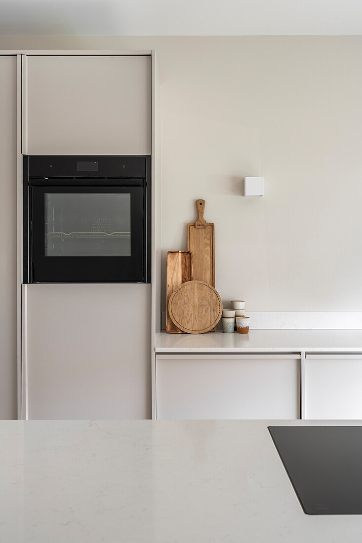 Kitchen with built-in oven and wooden chopping boards