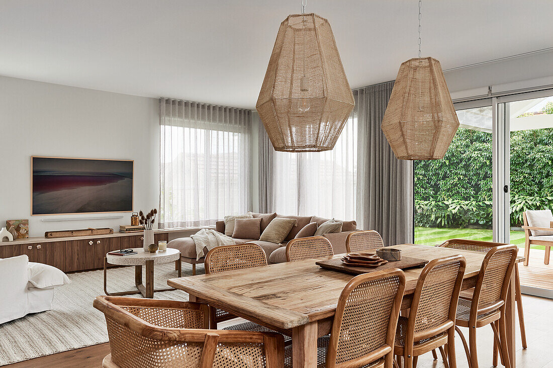 Dining area with rattan chairs in open-plan living room