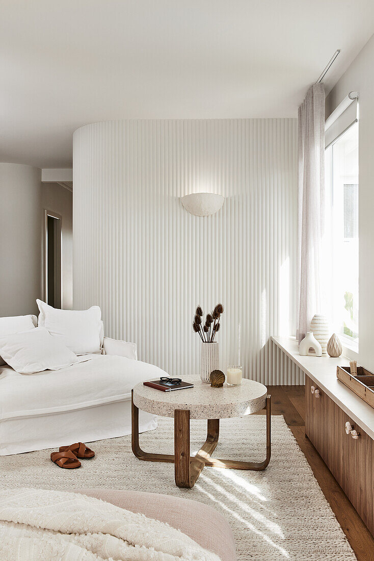 Living room in light colours with wooden elements