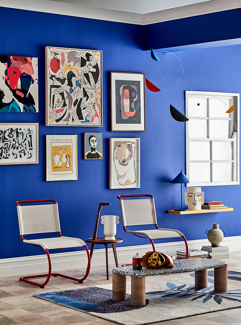 Gallery wall with colourful artwork in modern living room