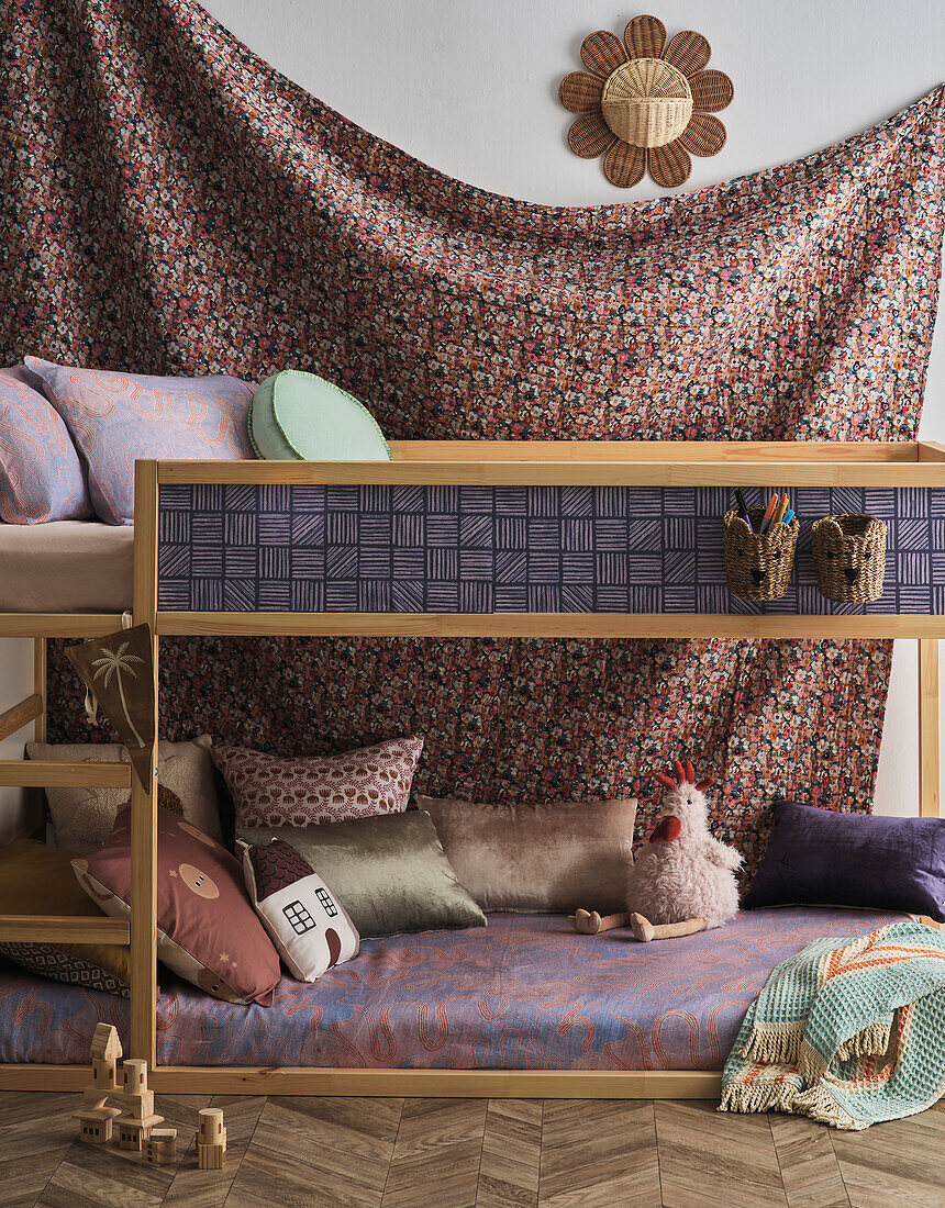 Children's room with bunk bed, colourful wall hanging and toys