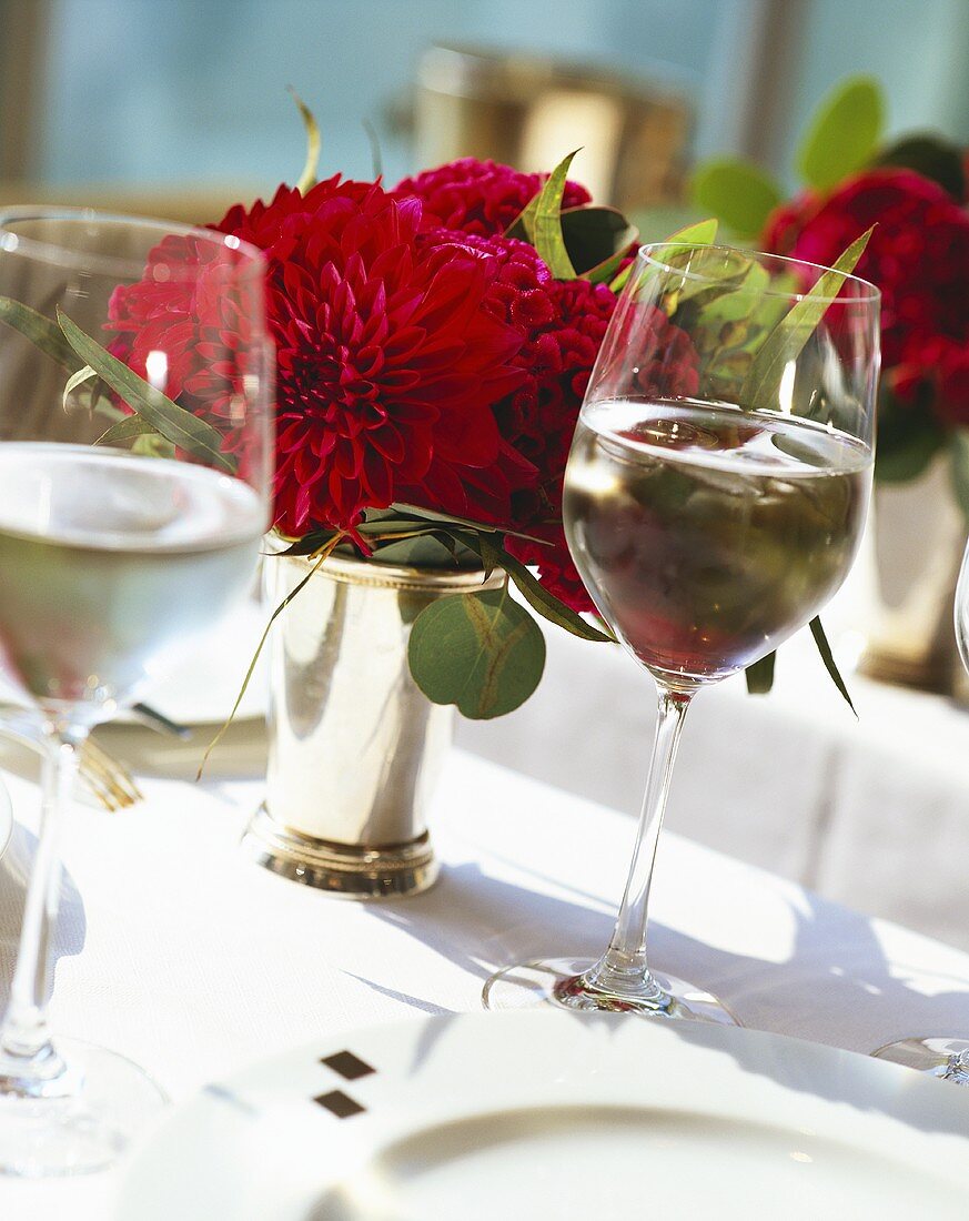 Laid table with flowers and wine glasses; close-up