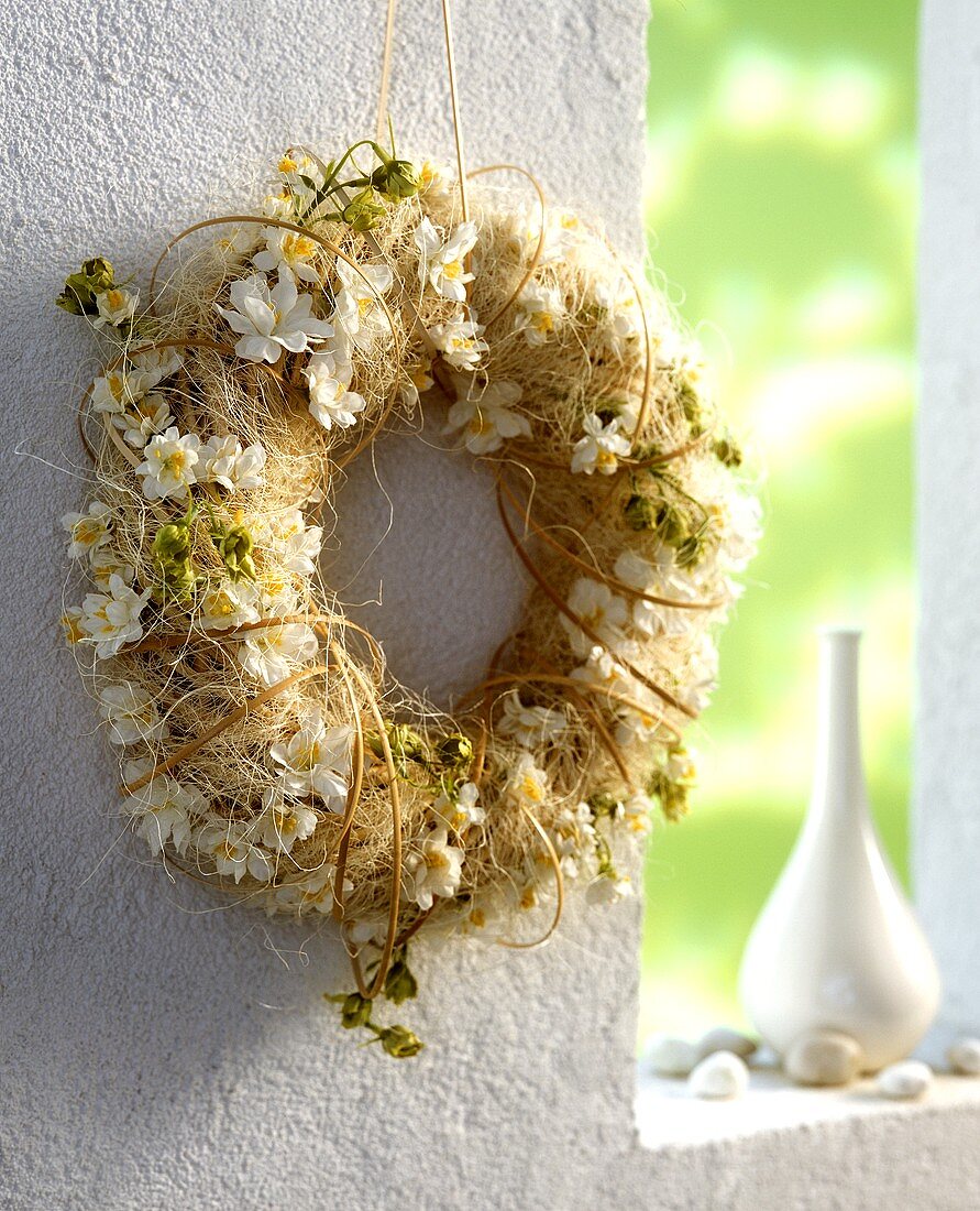Door wreath with white fabric flowers