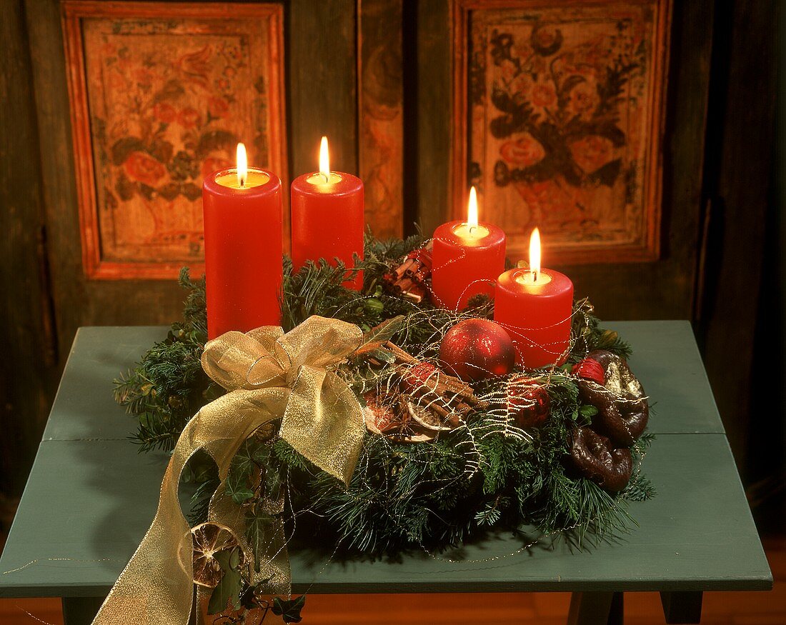 Advent flower arrangement with burning candles