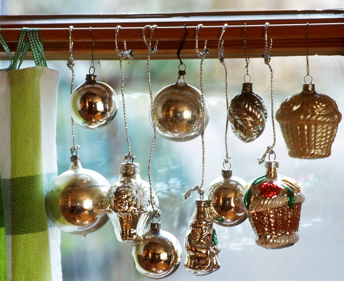 Silver Christmas tree ornaments as window decoration