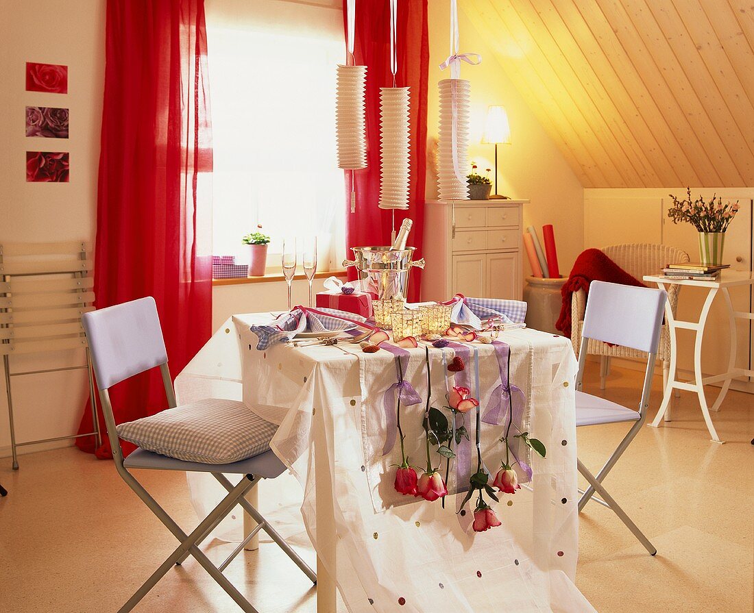 Romantic table for two with champagne and roses