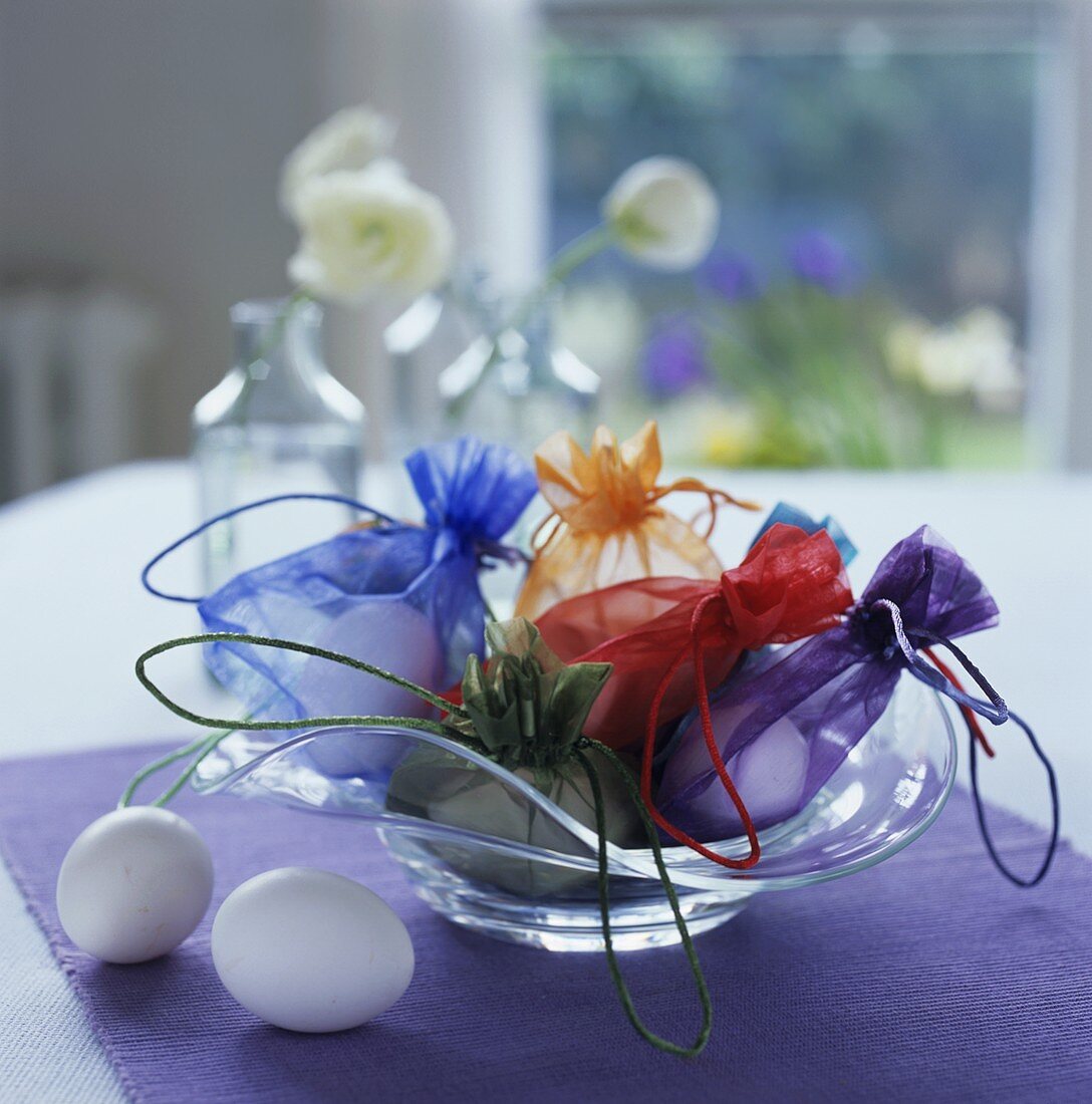 White eggs in coloured sacks as Easter decoration