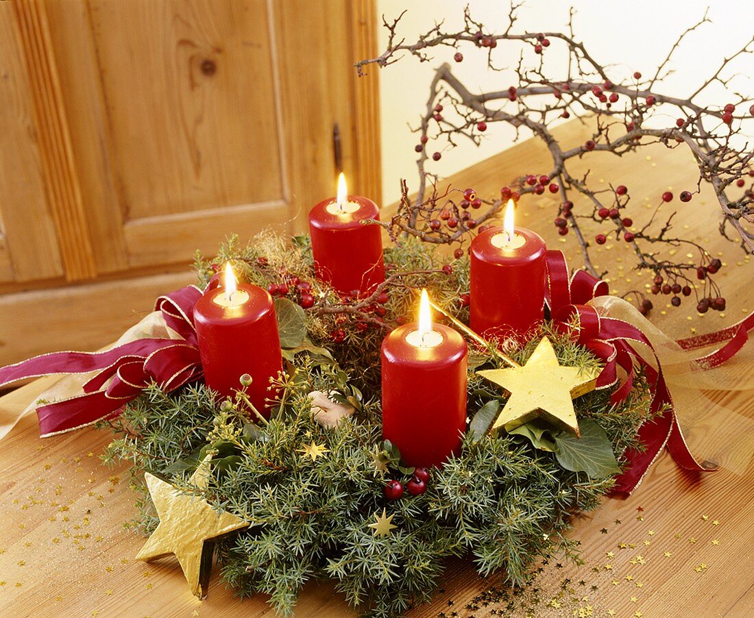 Advent wreath with four burning red candles