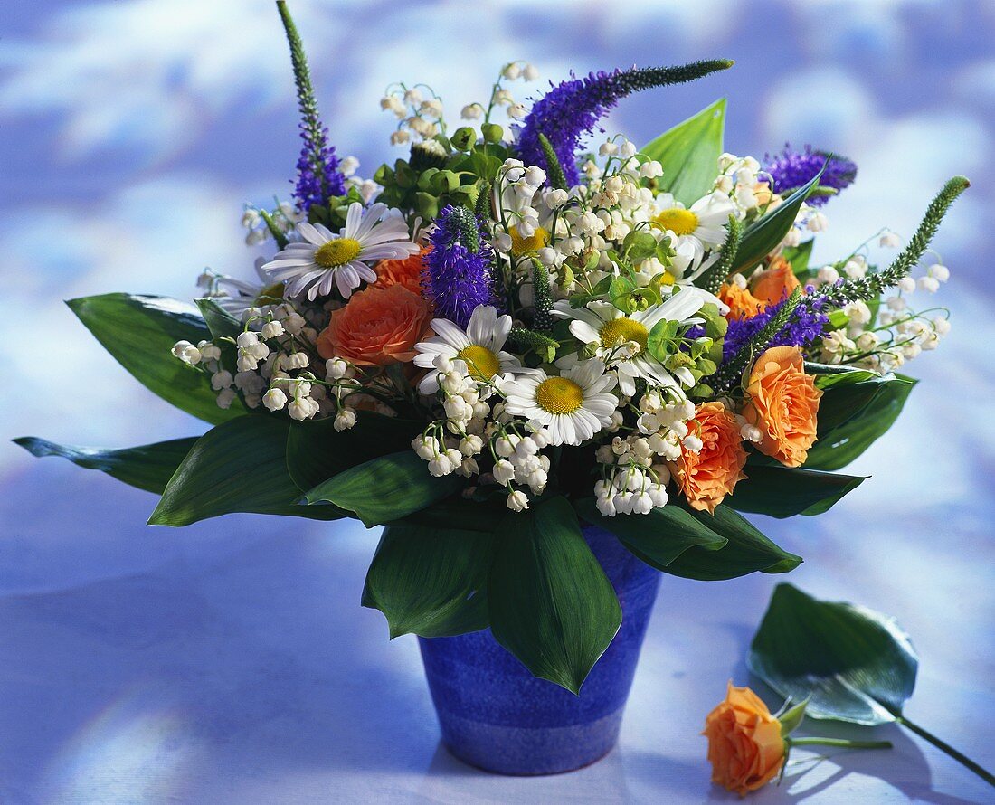 Colourful bouquet with lilies of the valley