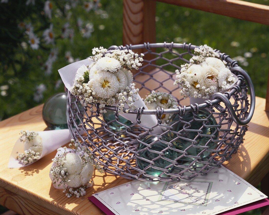 Metal basket with small bouquets of white flowers