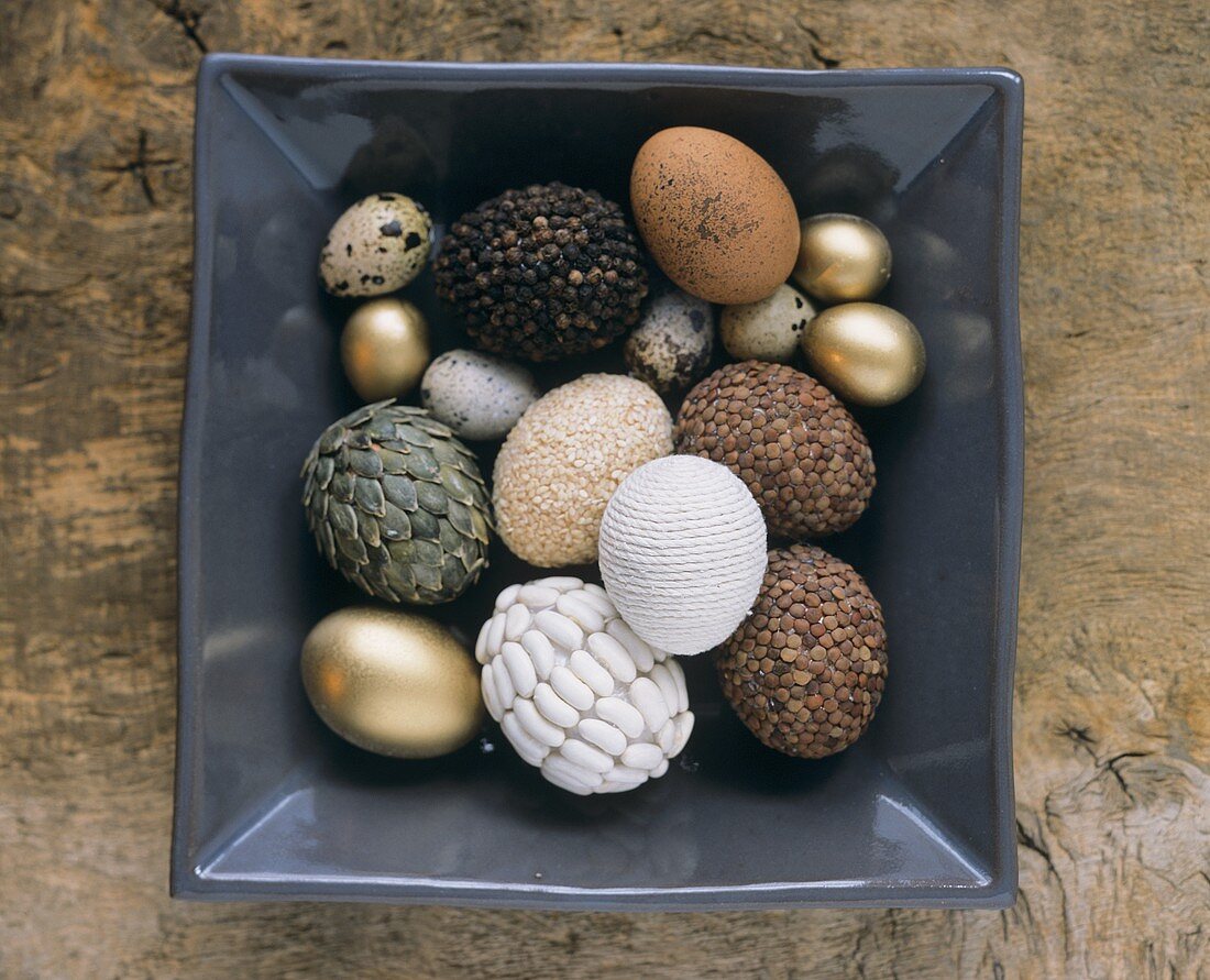 Various types of Easter eggs in a square bowl