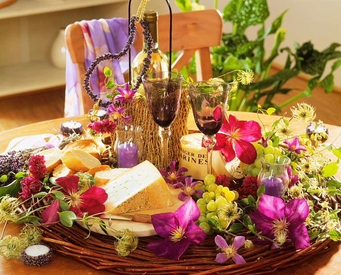 Cheese, wine, grapes, Clematis flowers and lavender