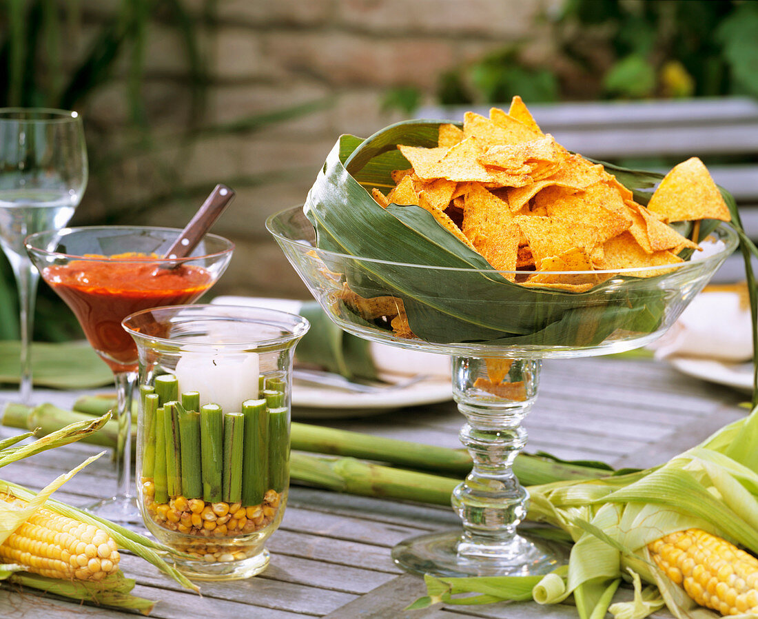 Nachos in a glass bowl with corn decoration