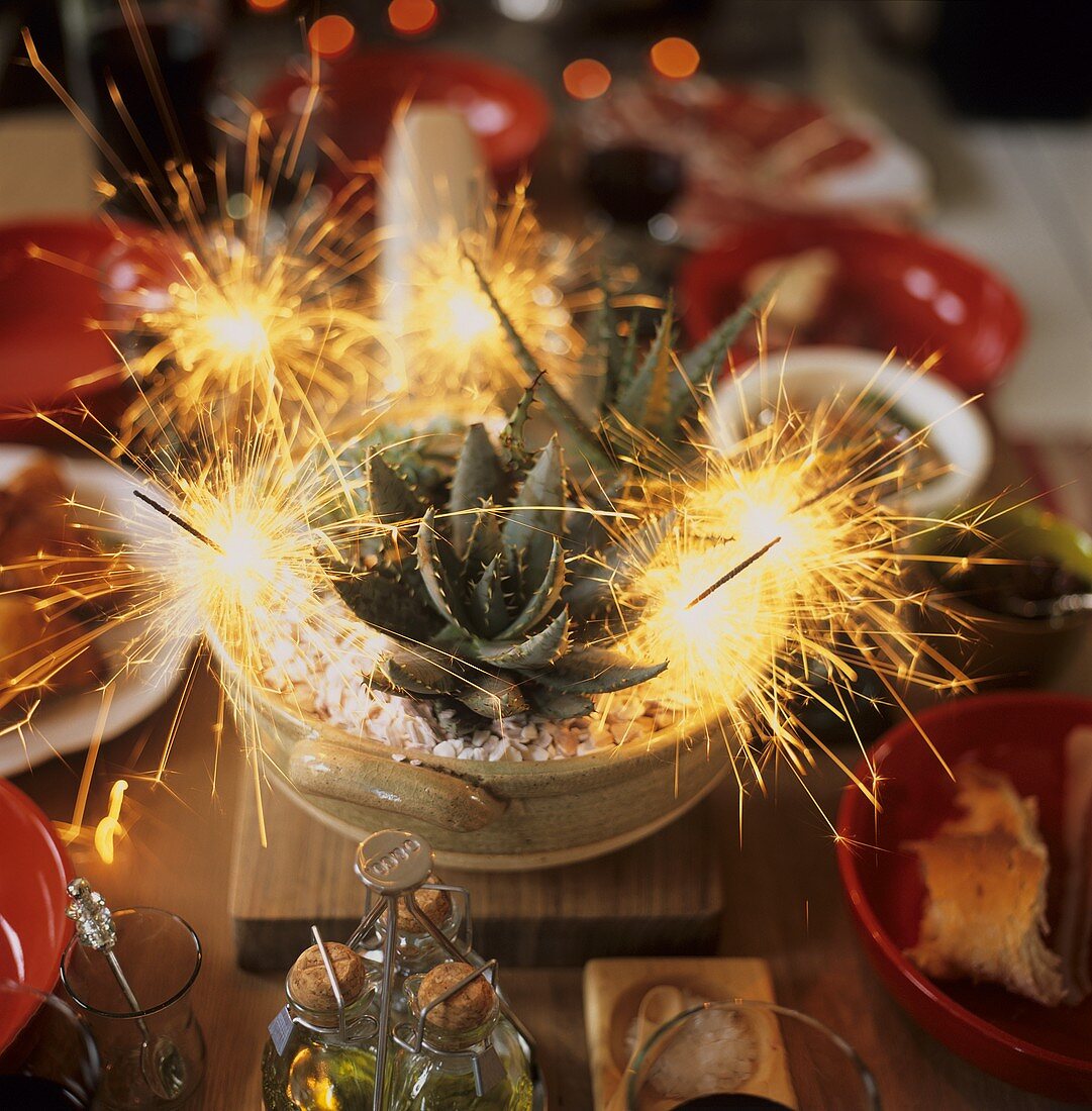 A laid table with burning sparklers