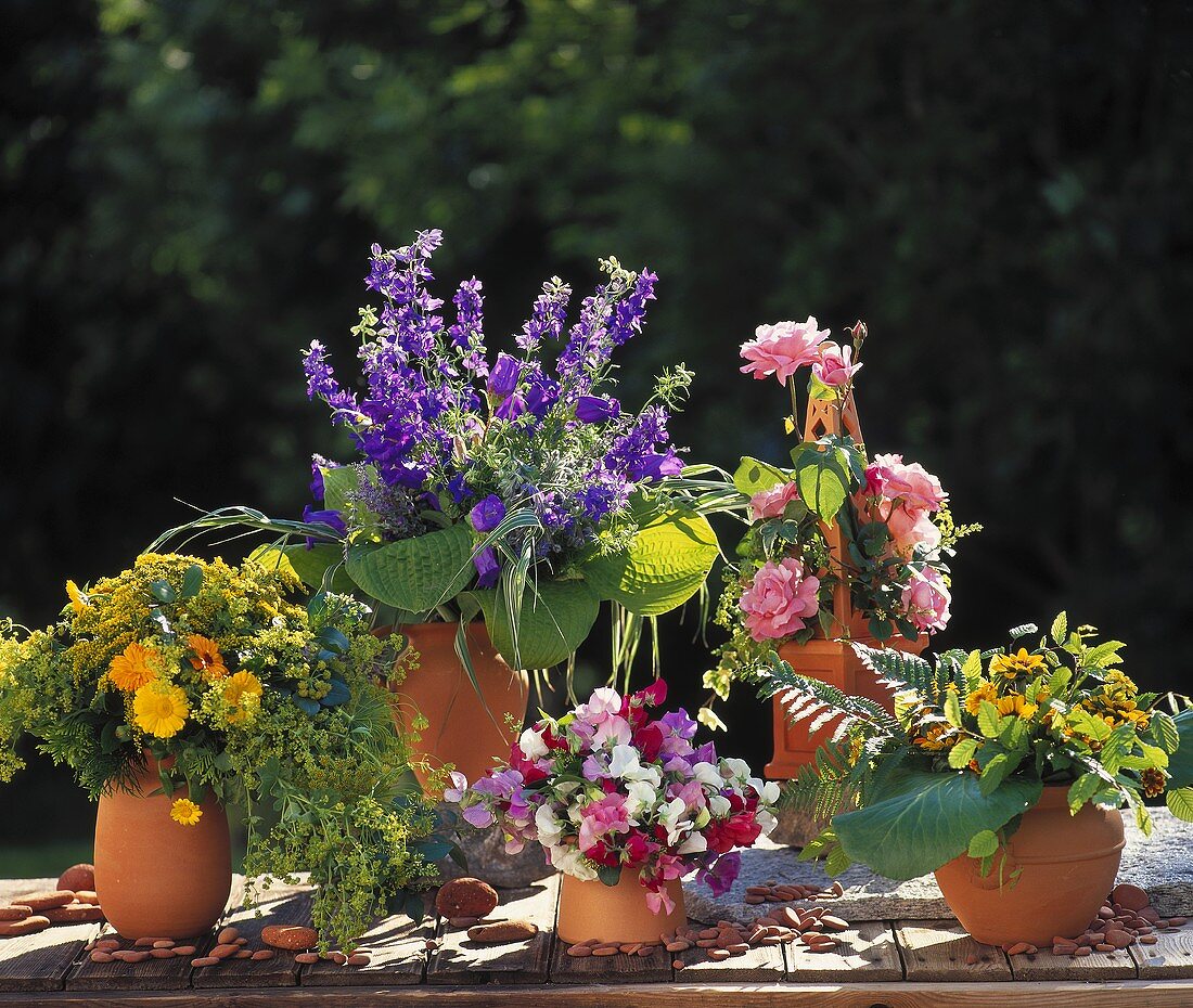 Vases of colourful summer flowers: roses, marigolds etc.