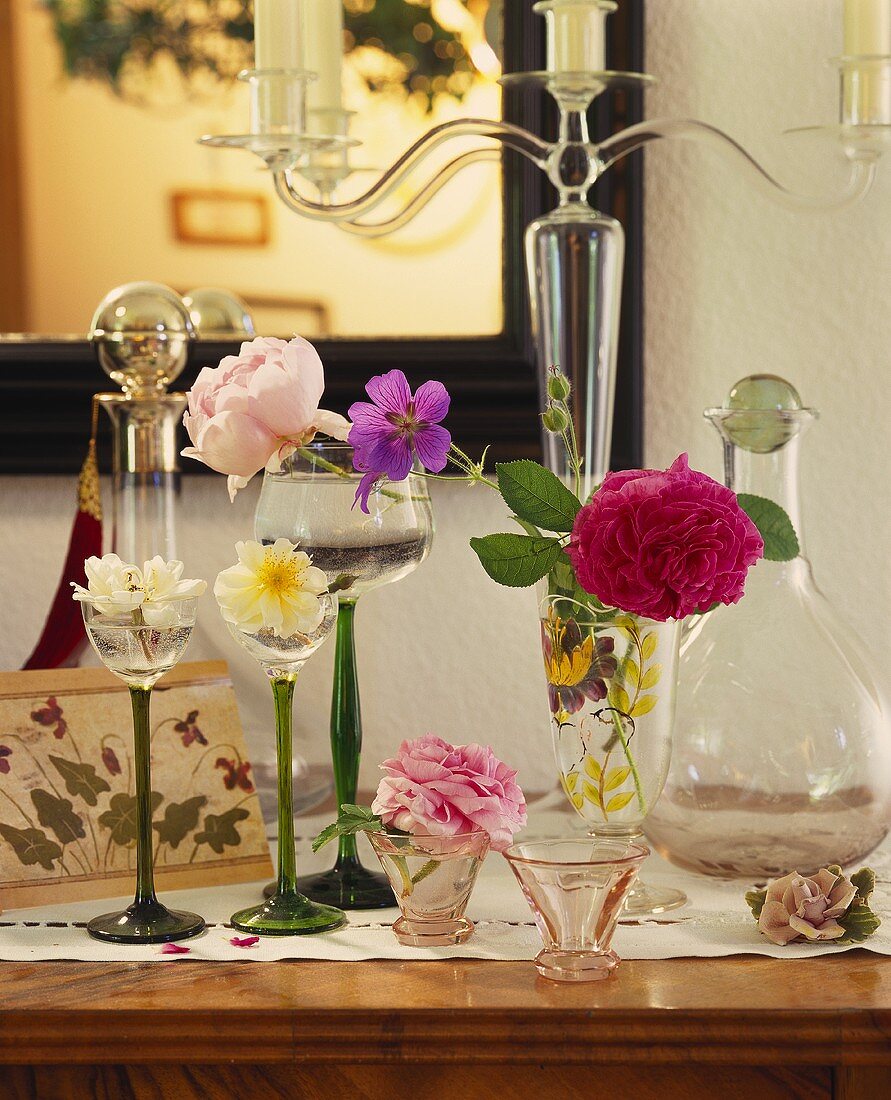 Liqueur and wine glasses with single flowers