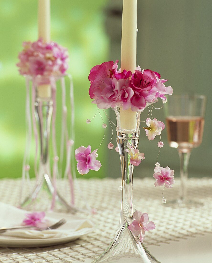 Candlestick with candle ring of pink silk flowers