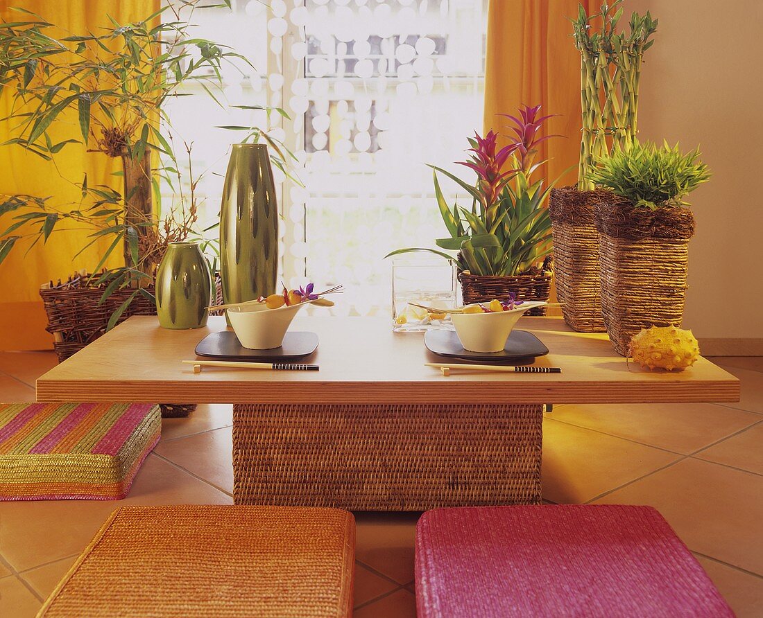 Oriental flair in dining room with bamboo and bromeliads