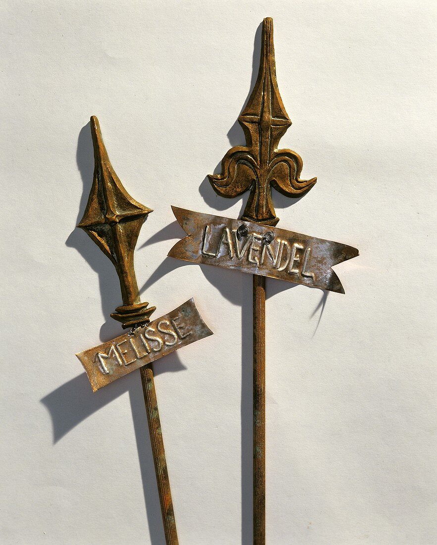 Metal plant stakes with rusty patina, with labels