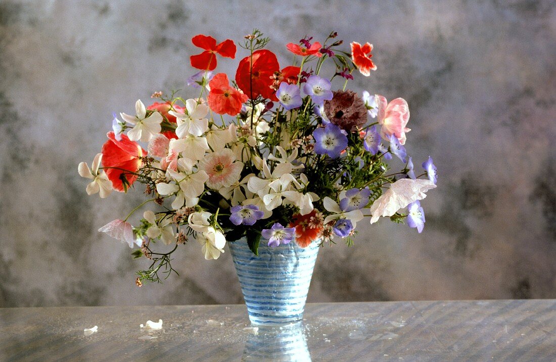 Summer bouquet of poppies and horned violets