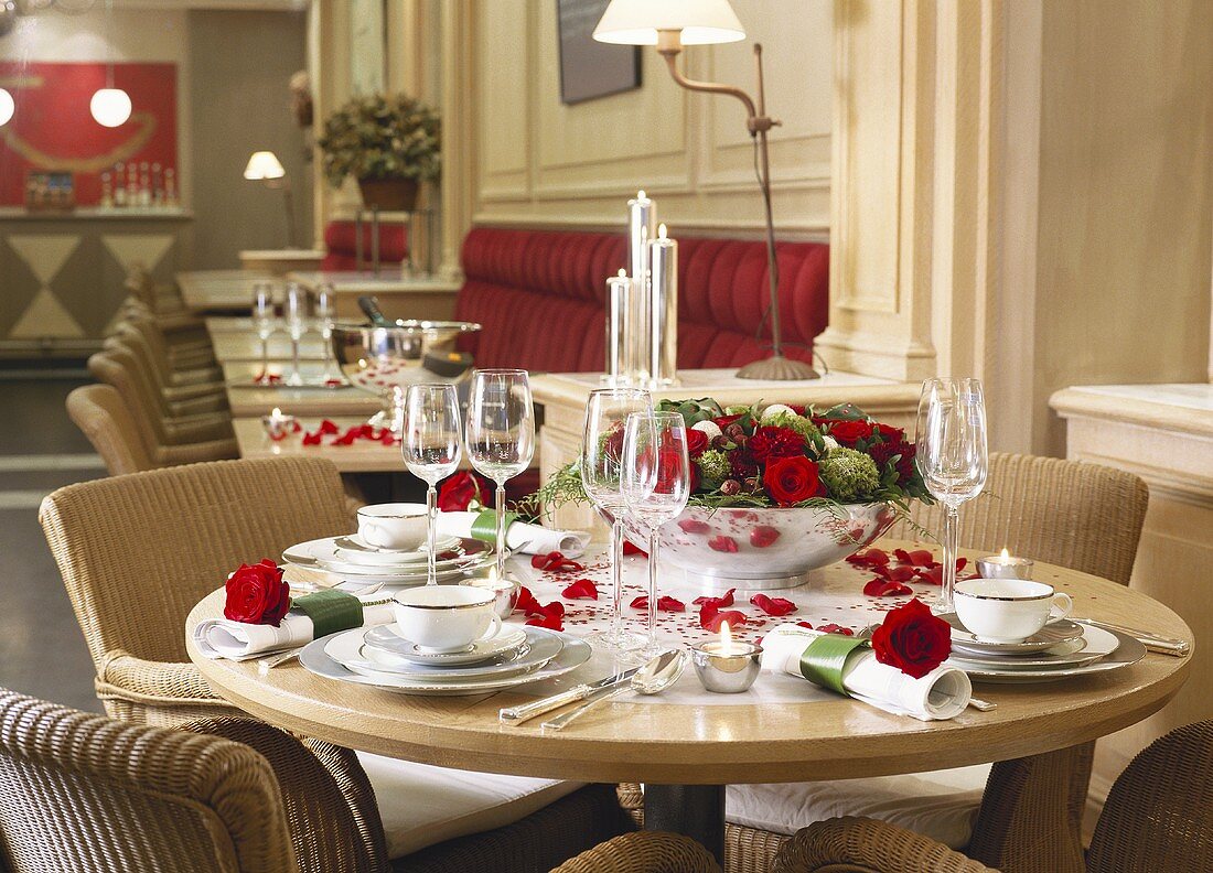 A festively laid table with red roses in a traditional restaurant