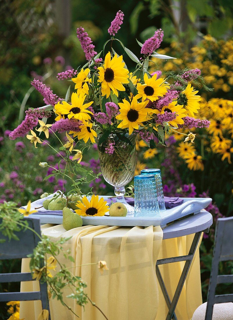 Vase of sunflowers and buddleia