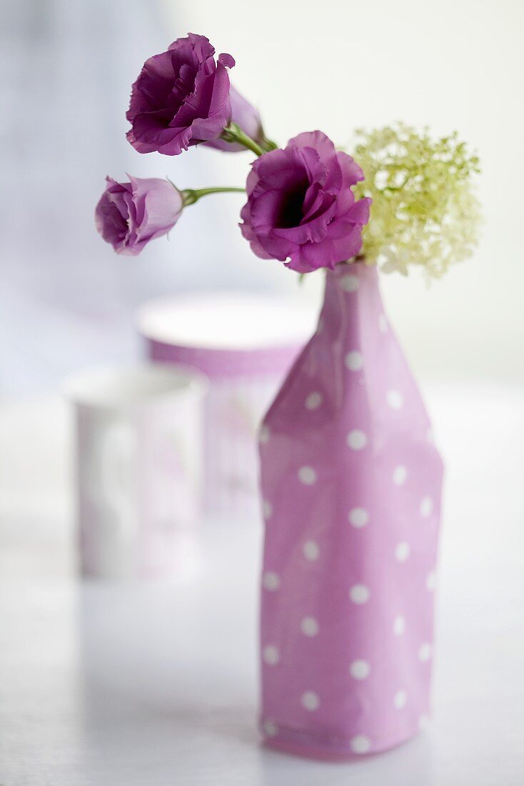Lisianthus and viburnums in a vase