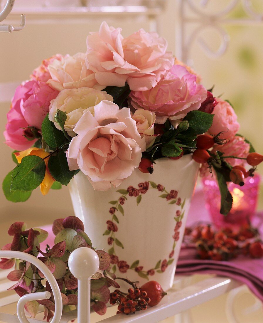Arrangement of roses with rose hips