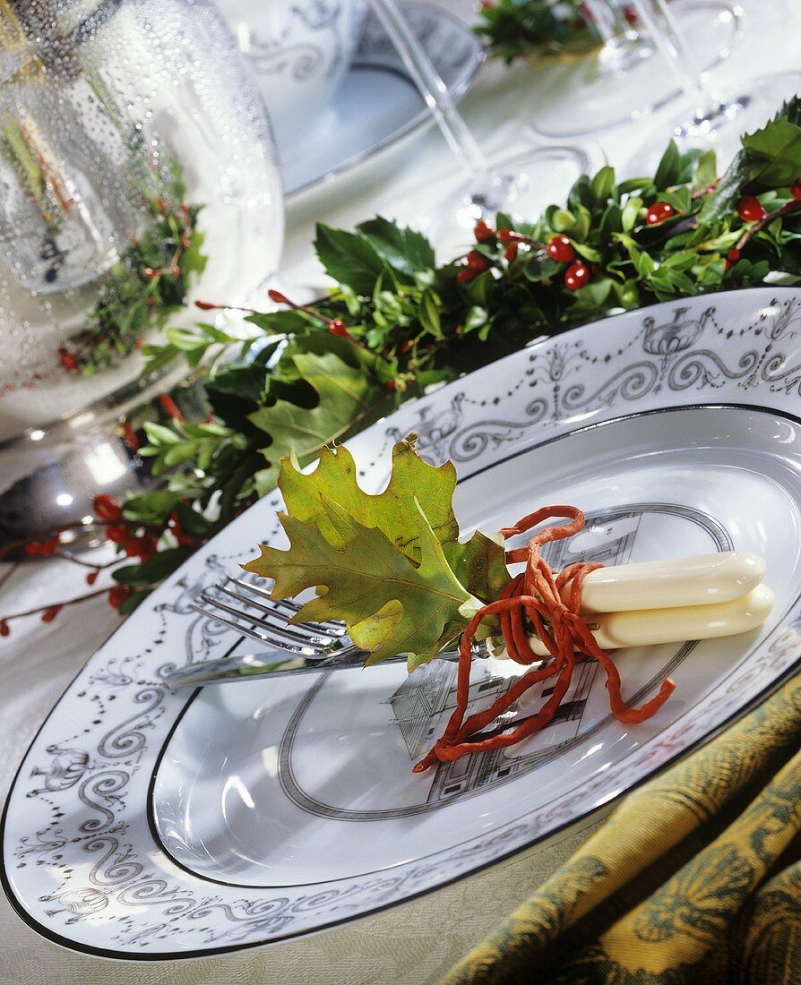 Festive place setting and holly