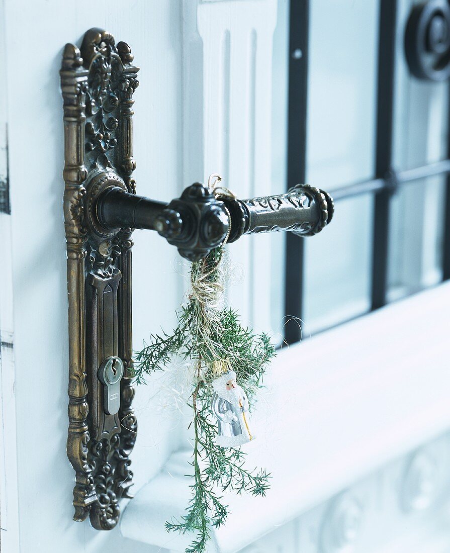Door handle with sprig of greenery and snow king
